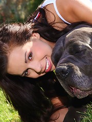 Naughty teen Kiki posing with huge dog outdoors